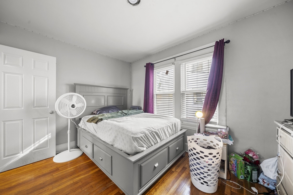 708-710 Carew Street Springfield, MA 01104 - Photo 13 of 38 a bed sitting in a bedroom next to a window