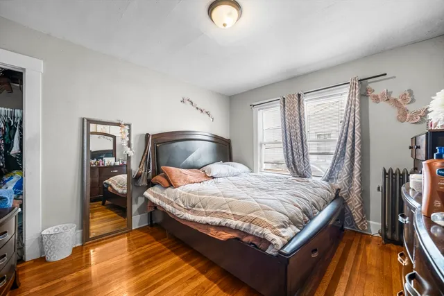 a bedroom with bed and a window