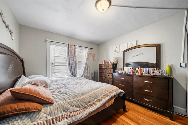 a bedroom with a bed and dresser