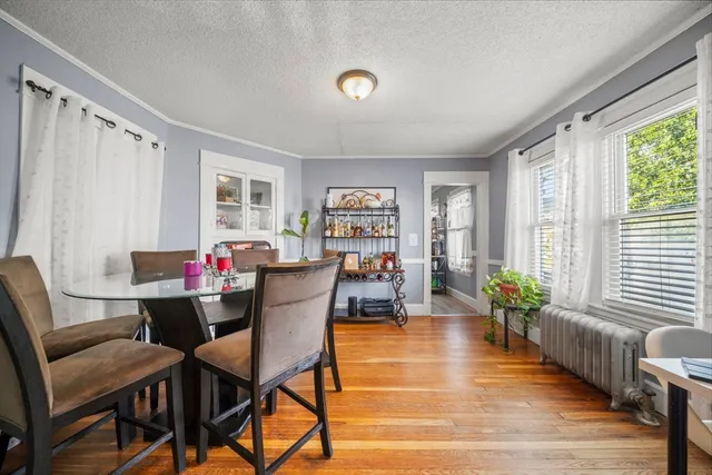 a dining room with furniture and wooden floor