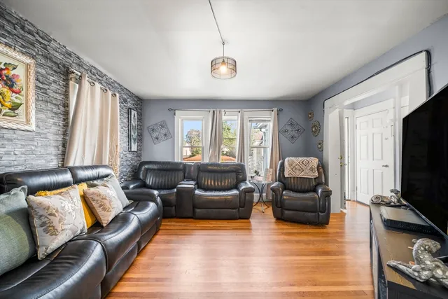 a living room with furniture window and a flat screen tv