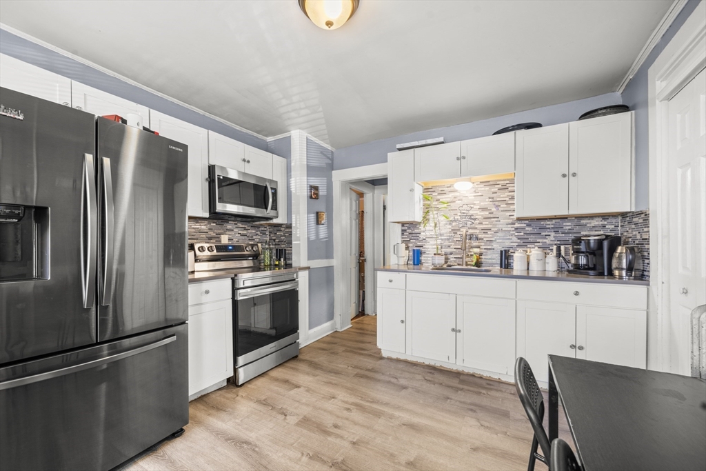 708-710 Carew Street Springfield, MA 01104 - Photo 2 of 38 a kitchen with granite countertop a refrigerator stove and microwave