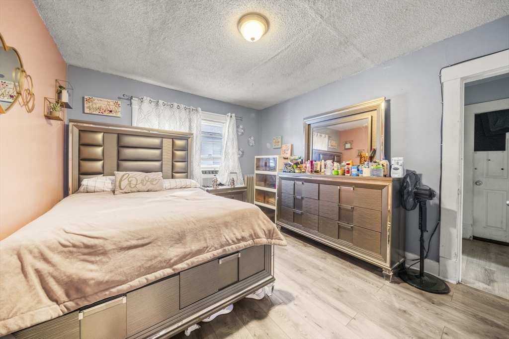 708-710 Carew Street Springfield, MA 01104 - Photo 27 of 38 a bedroom with a bed and a dresser