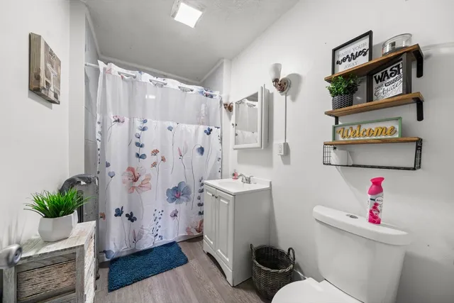 a bathroom with a sink toilet and shower