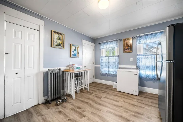 a kitchen with stainless steel appliances a refrigerator sink and white cabinets