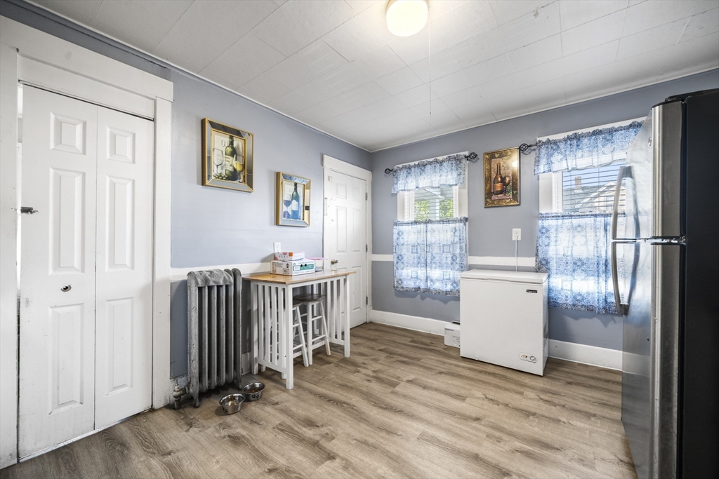 708-710 Carew Street Springfield, MA 01104 - Photo 30 of 38 a view of a room with wooden floor kitchen ceiling fan and windows