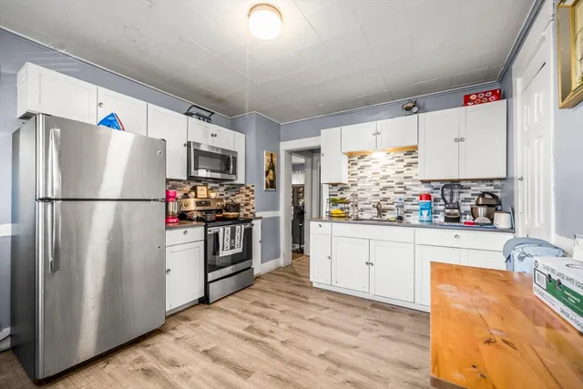 a kitchen with stainless steel appliances granite countertop a stove and a sink