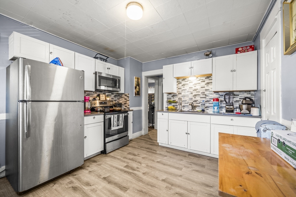 708-710 Carew Street Springfield, MA 01104 - Photo 31 of 38 a kitchen with stainless steel appliances a refrigerator sink and white cabinets