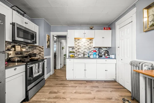 a kitchen with stainless steel appliances a refrigerator microwave and sink