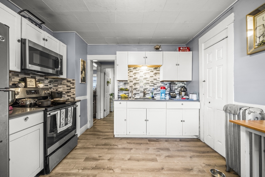 708-710 Carew Street Springfield, MA 01104 - Photo 32 of 38 a kitchen with stainless steel appliances granite countertop a stove and a sink