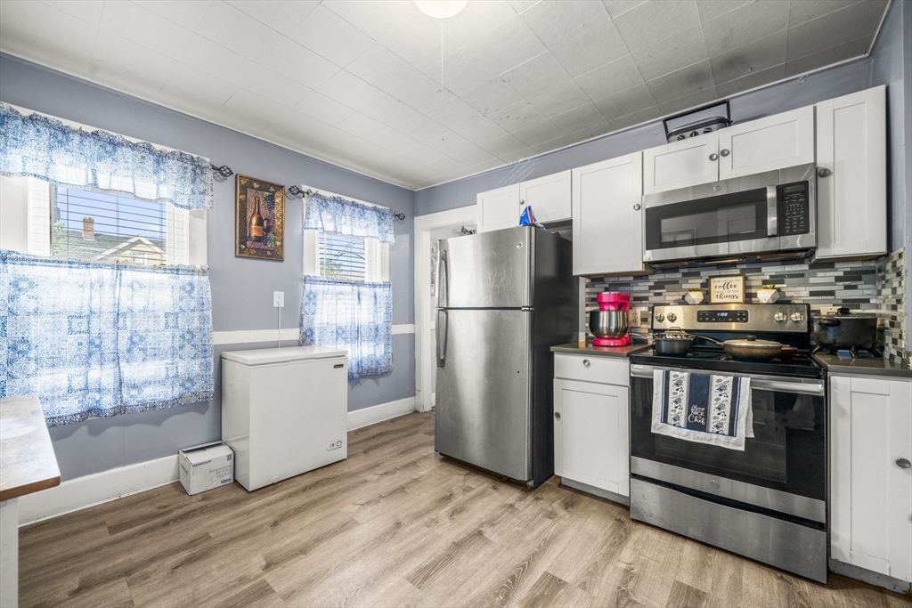 708-710 Carew Street Springfield, MA 01104 - Photo 33 of 38 a kitchen with stainless steel appliances a refrigerator microwave and sink