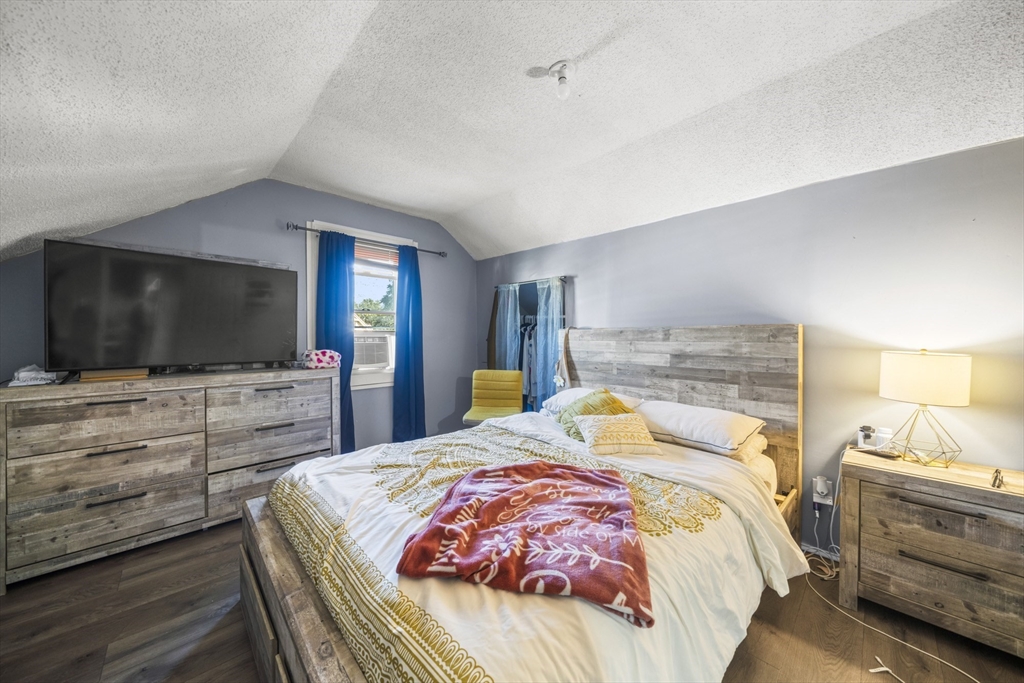 708-710 Carew Street Springfield, MA 01104 - Photo 34 of 38 a bedroom with a bed and a flat screen tv