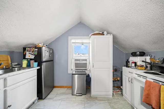 a kitchen with stainless steel appliances granite countertop a refrigerator a stove a sink and dishwasher