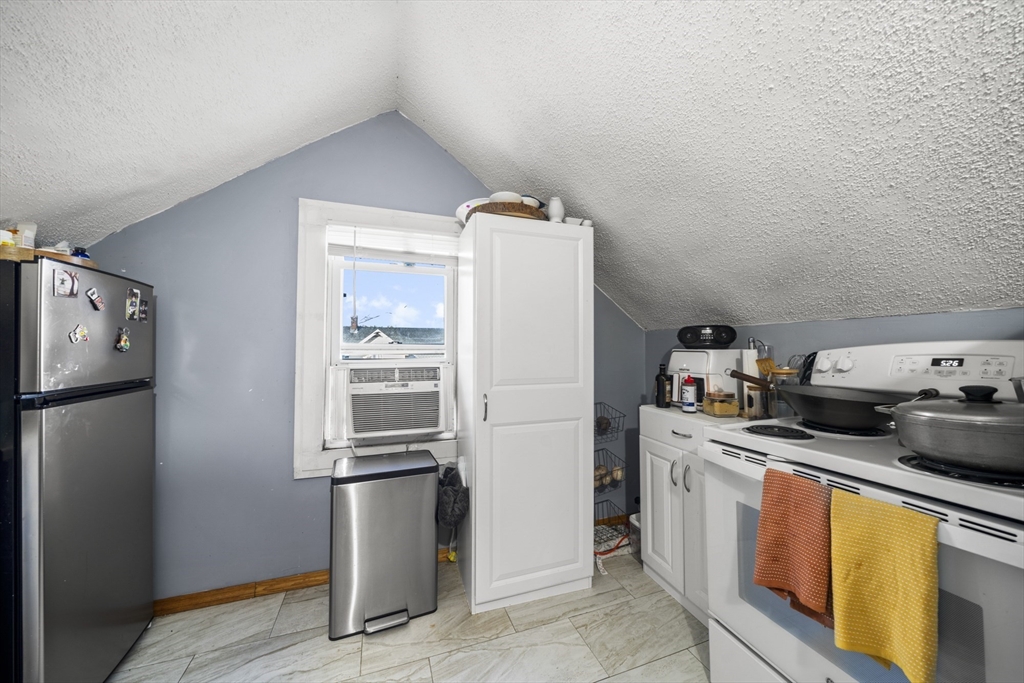 708-710 Carew Street Springfield, MA 01104 - Photo 36 of 38 a kitchen with stainless steel appliances granite countertop a refrigerator a stove a sink and dishwasher