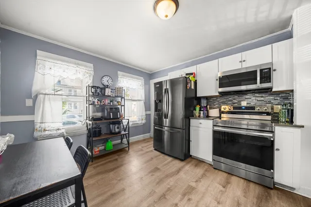 a kitchen with stainless steel appliances a stove microwave and a refrigerator