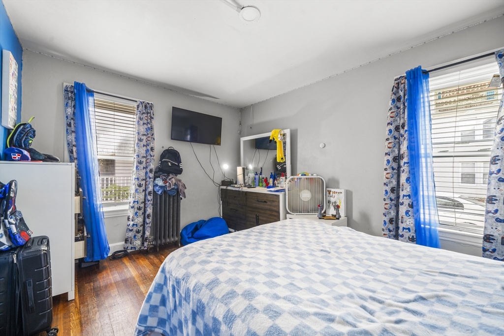 708-710 Carew Street Springfield, MA 01104 - Photo 6 of 38 a bedroom with a bed and a flat tv screen