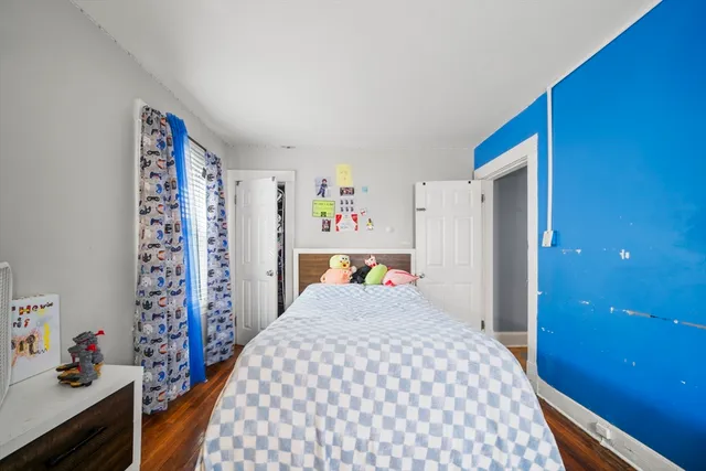 a bedroom with a bed and a dresser