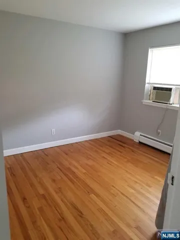 a view of a room with wooden floor and fan