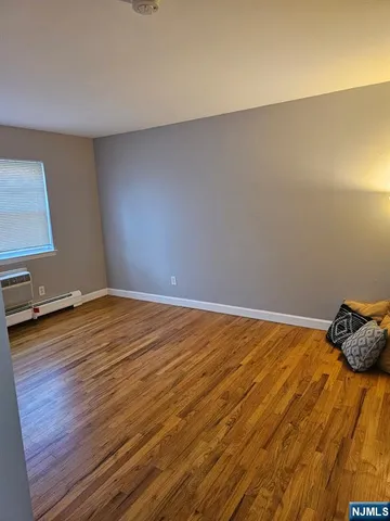 a view of a room with wooden floor