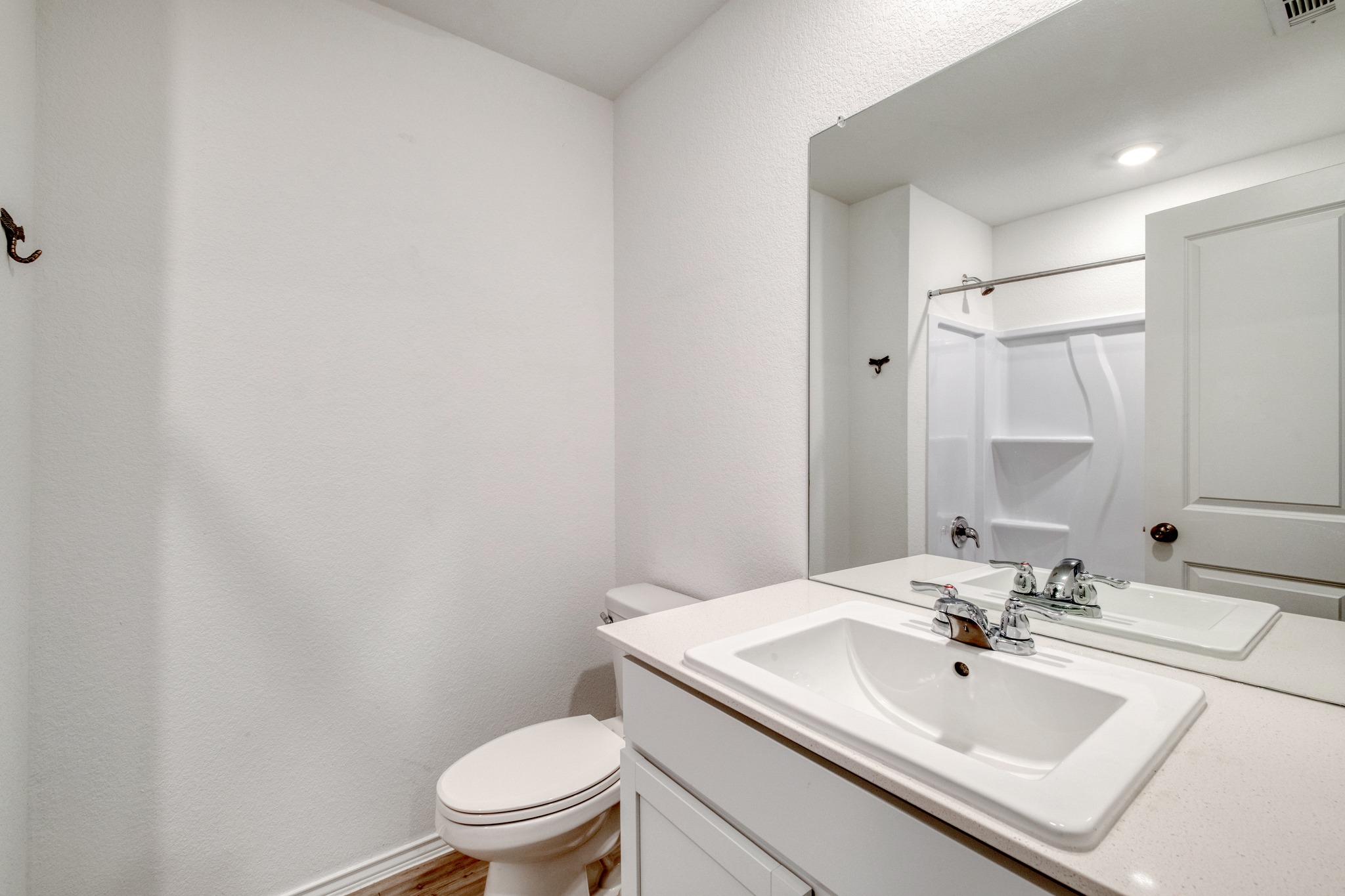23412 Tiny Moons Way Elgin, TX 78621 - Photo 27 of 38 Bathroom featuring a vanity with an integrated sink, polished chrome faucet, and a large wall-mounted mirror