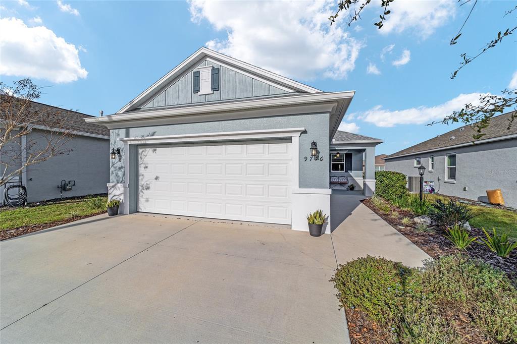 9776 Southwest 100th Avenue Ocala, FL 34481 - Photo 3 of 52 a front view of a house with garage