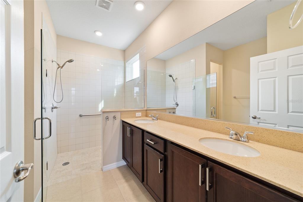9776 Southwest 100th Avenue Ocala, FL 34481 - Photo 33 of 52 a bathroom with a double vanity sink mirror double and shower