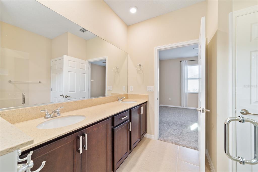 9776 Southwest 100th Avenue Ocala, FL 34481 - Photo 34 of 52 a spacious bathroom with a double vanity sink mirror and