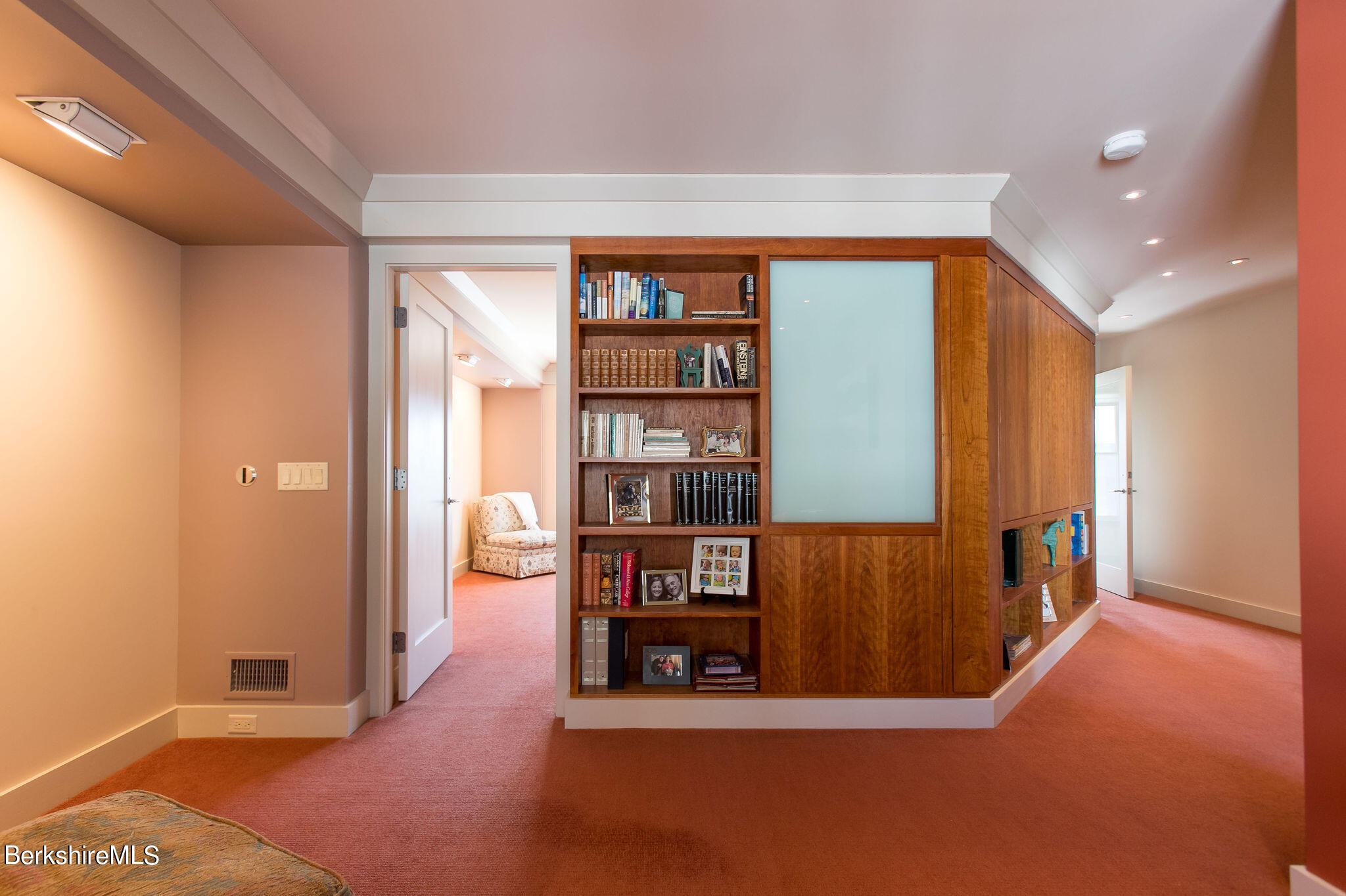200 Old Stockbridge Road, Unit 3B Lenox, MA 01240 - Photo 11 of 36 a view of an empty room with bookshelf and wooden floor
