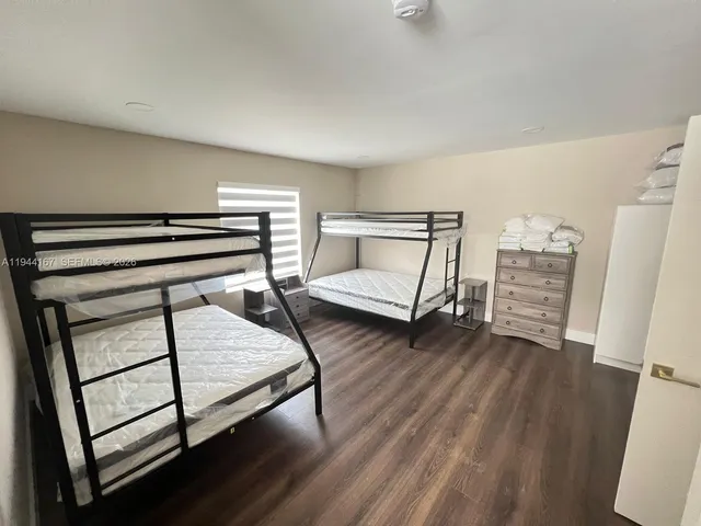a bedroom with furniture and a wooden floor