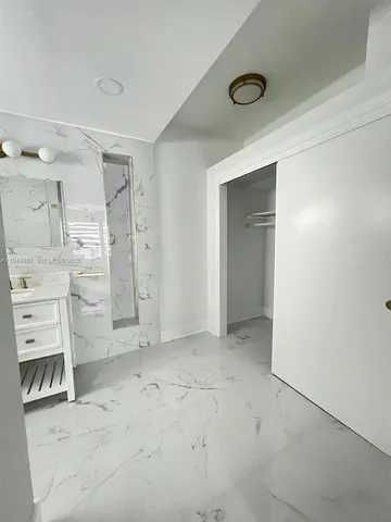 an empty room with a fireplace and cabinets