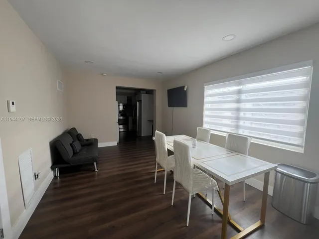 a view of a dining room with furniture window and wooden floor