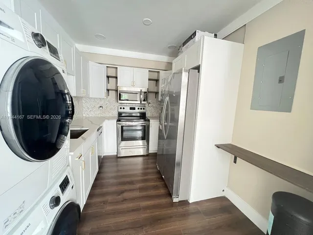 a kitchen with a refrigerator and washer