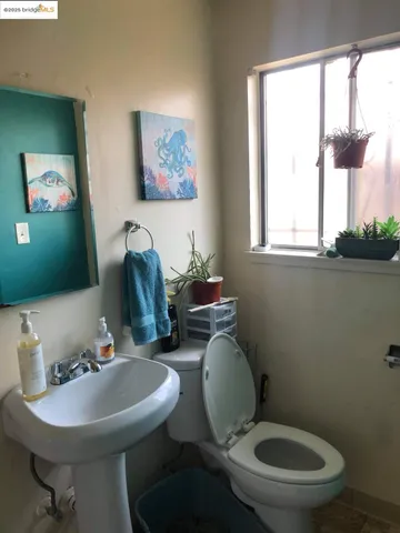a bathroom with a toilet a sink and a mirror