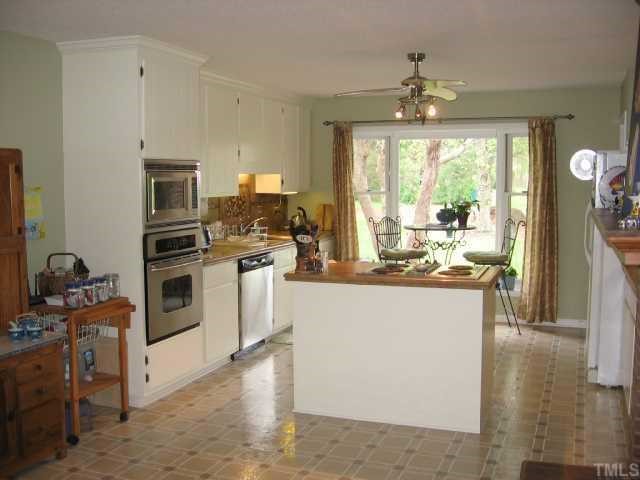 6315 Guess Road Rougemont, NC 27572 - Photo 9 of 12 a kitchen with a sink stove and refrigerator