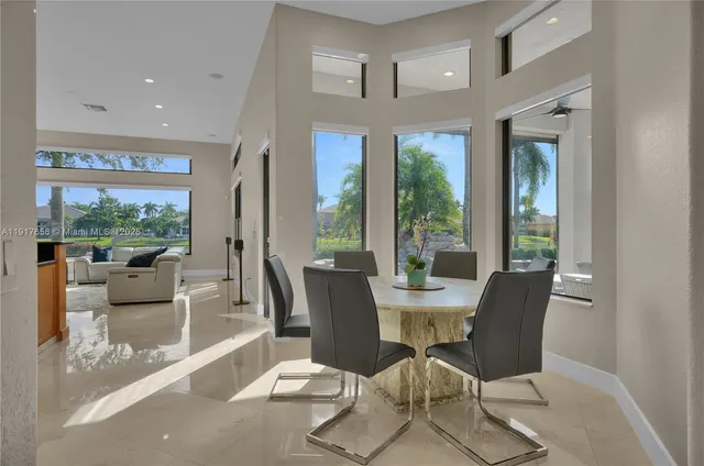 a living room with furniture and a floor to ceiling window