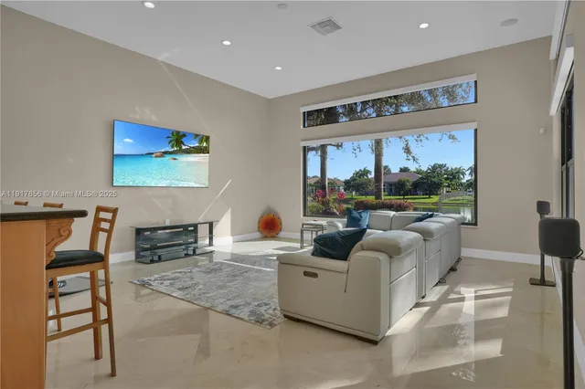 a living room with furniture and a floor to ceiling window