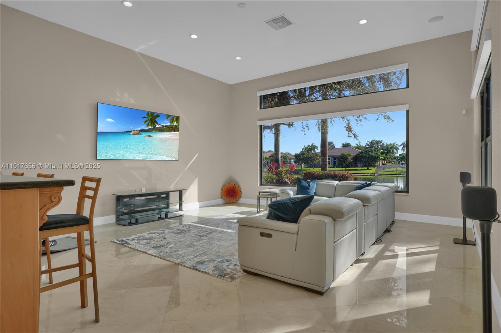 14896 Southwest 38th Street Davie, FL 33331 - Photo 18 of 60 a living room with furniture and a flat screen tv