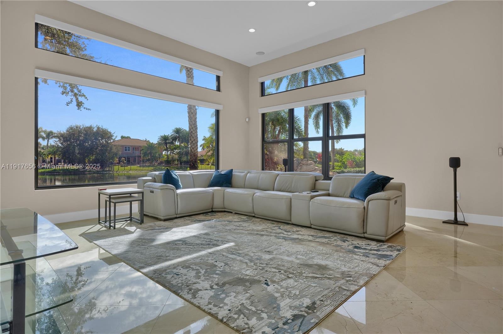 14896 Southwest 38th Street Davie, FL 33331 - Photo 19 of 60 a living room with furniture and a floor to ceiling window