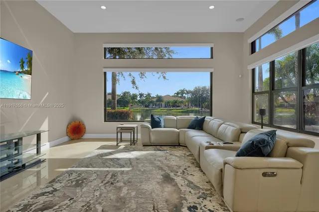 a kitchen with stainless steel appliances a refrigerator a stove a sink a dining table and chairs