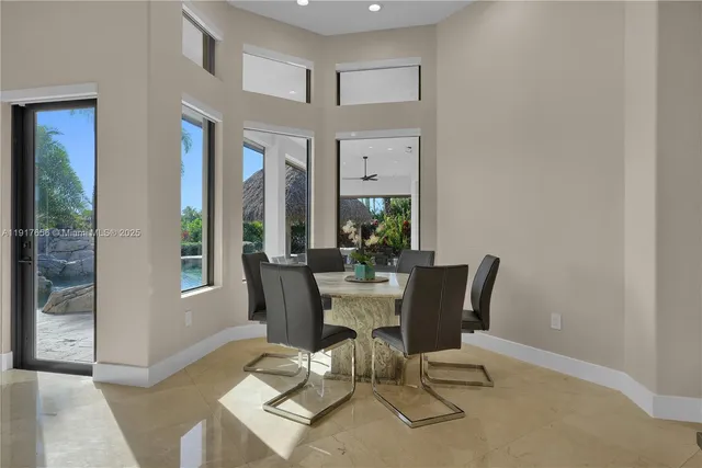 a kitchen with stainless steel appliances granite countertop a stove a sink a oven a dining table and chairs