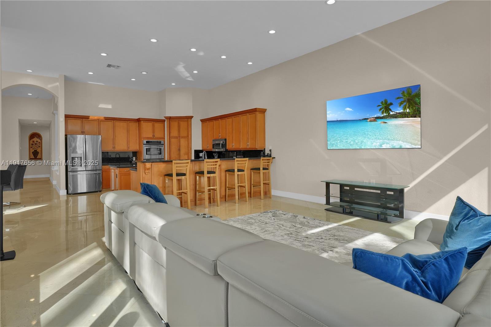 14896 Southwest 38th Street Davie, FL 33331 - Photo 25 of 60 a living room with furniture and a flat screen tv