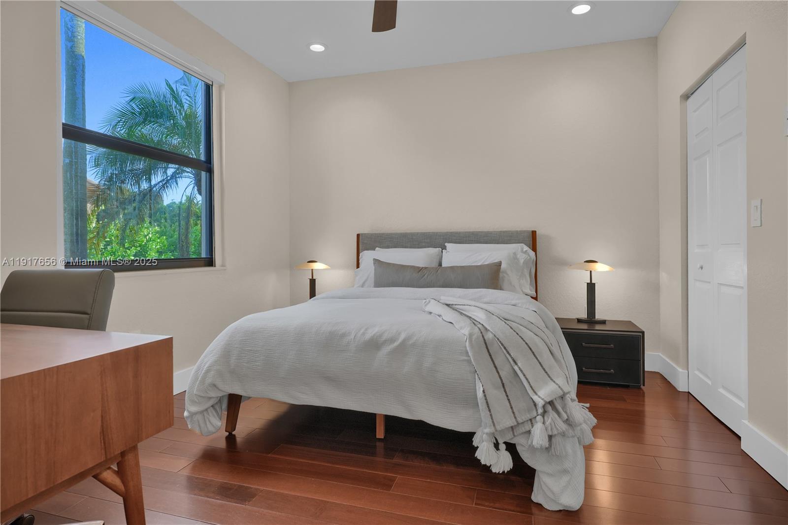 14896 Southwest 38th Street Davie, FL 33331 - Photo 27 of 60 a bedroom with a bed and a lamp on table