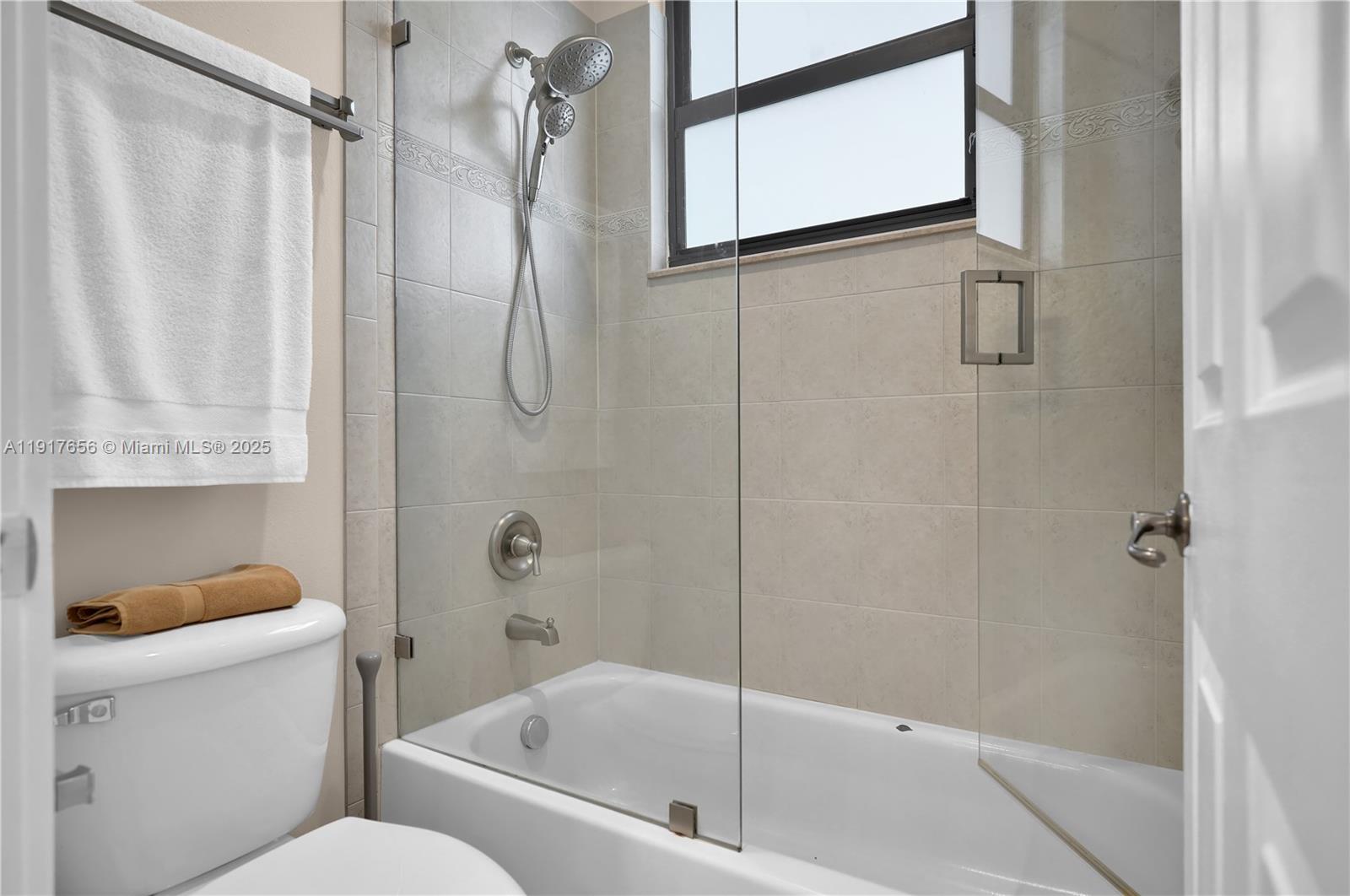 14896 Southwest 38th Street Davie, FL 33331 - Photo 28 of 60 a bathroom with a shower and a toilet