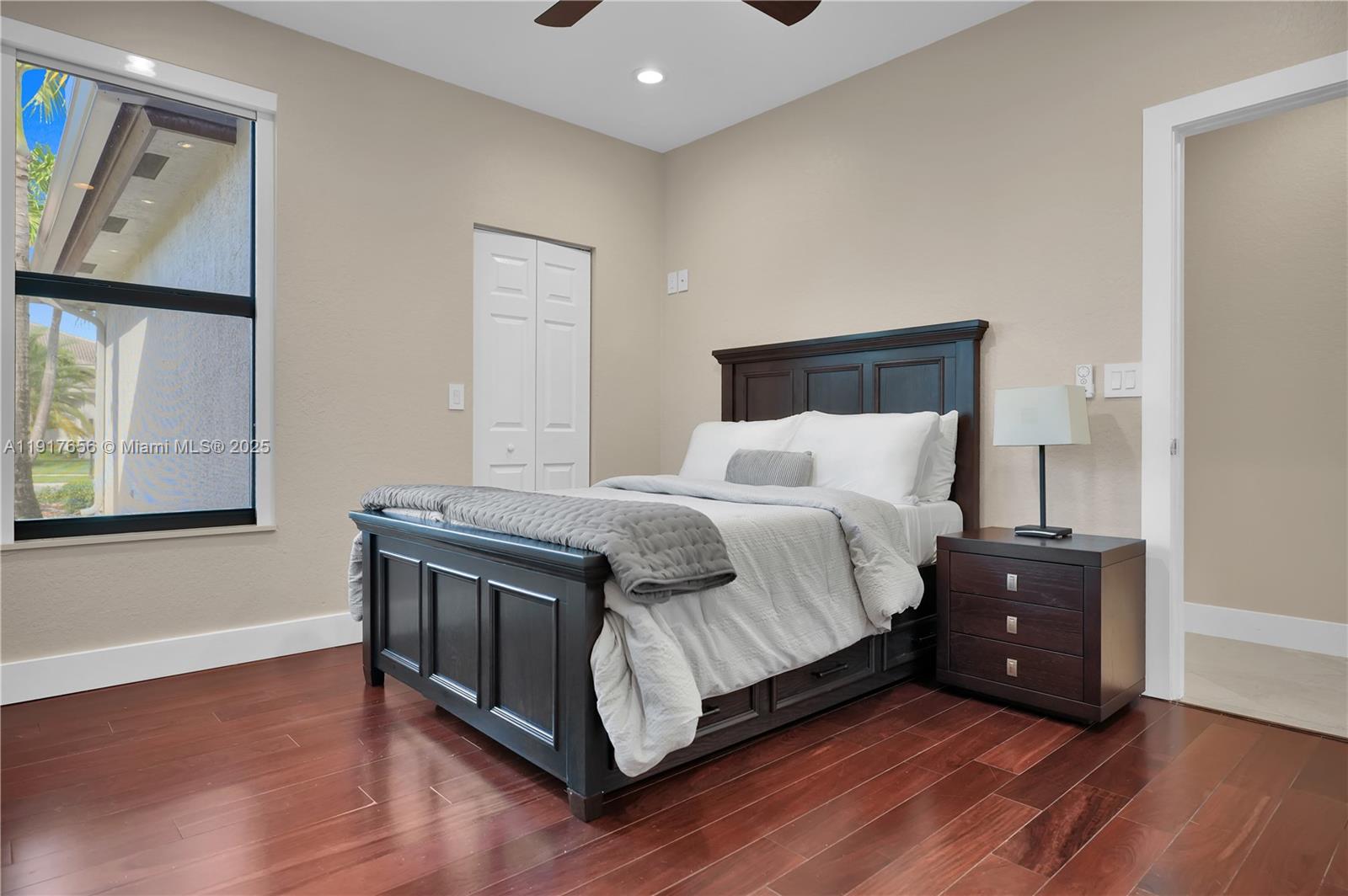 14896 Southwest 38th Street Davie, FL 33331 - Photo 32 of 60 a bedroom with a bed and painting on the wall