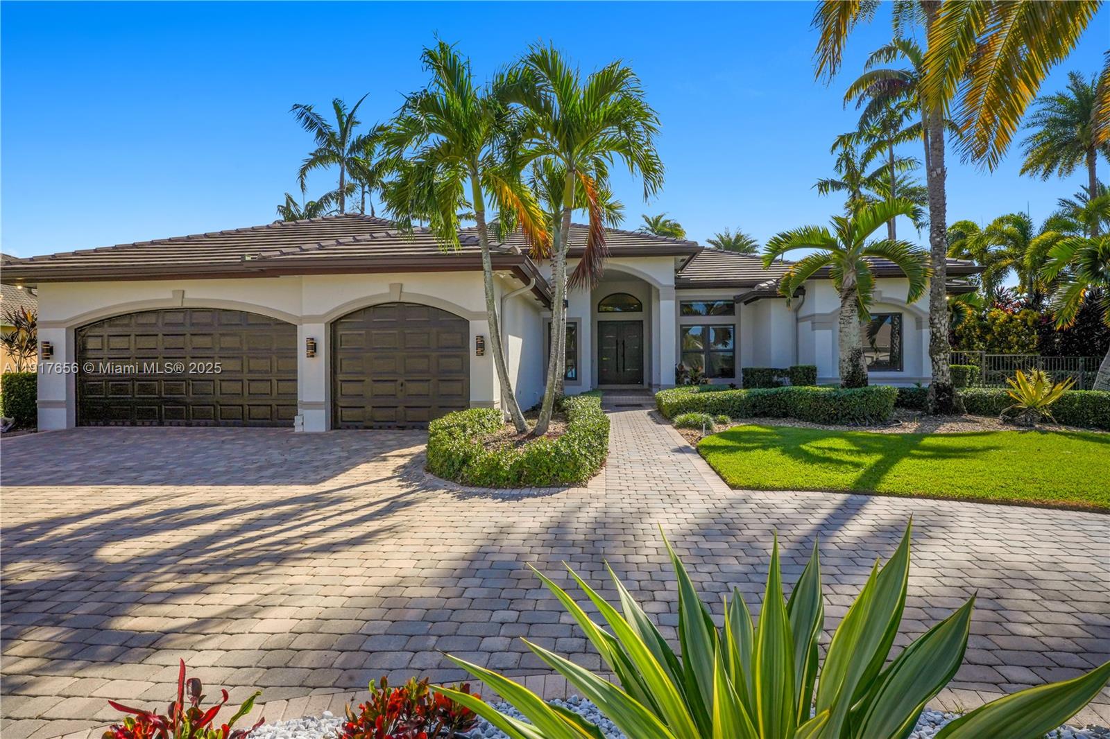 14896 Southwest 38th Street Davie, FL 33331 - Photo 4 of 60 a front view of a house with a yard and potted plants