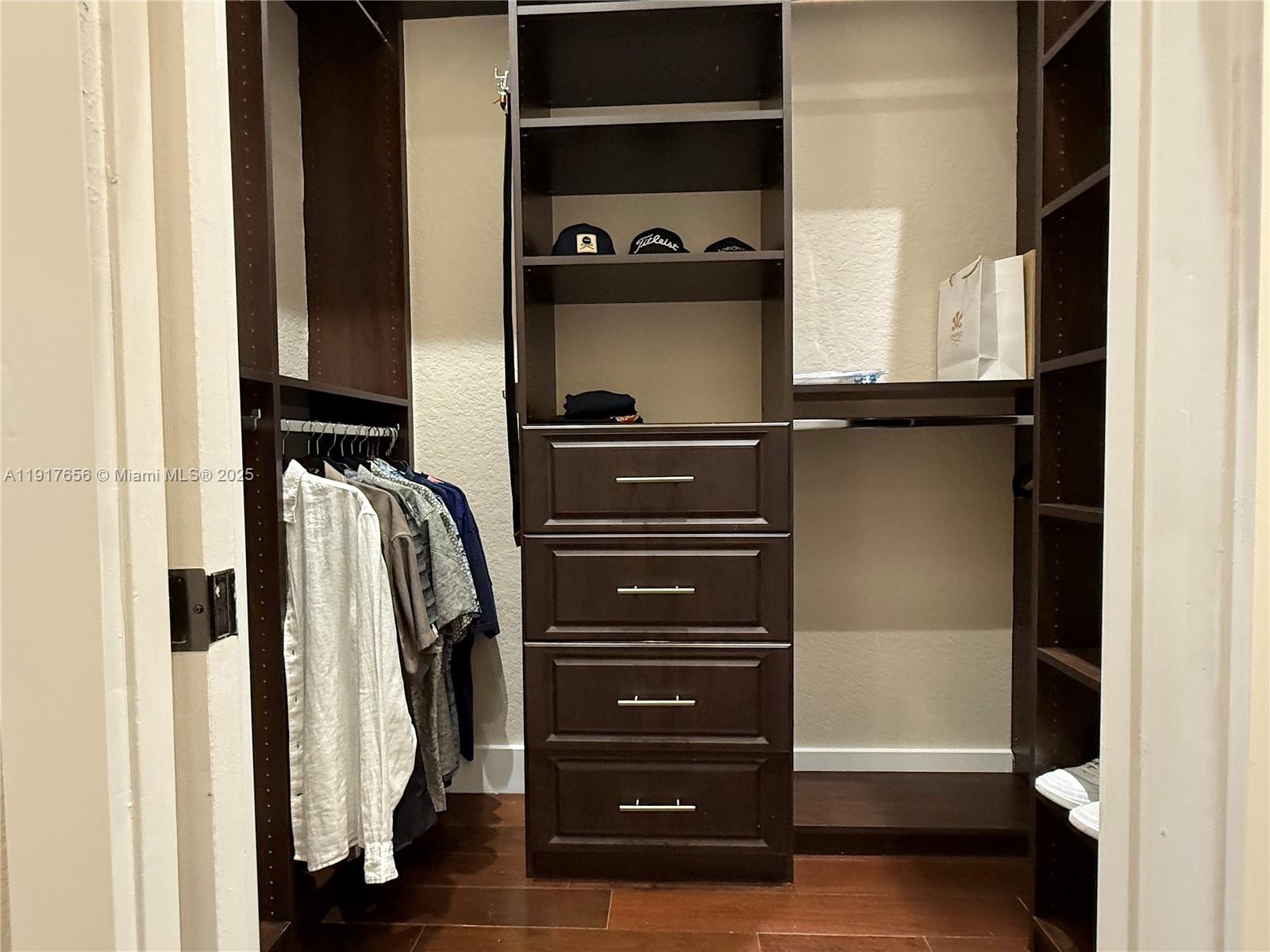 14896 Southwest 38th Street Davie, FL 33331 - Photo 42 of 60 a view of walk in closet with clothes and shoes