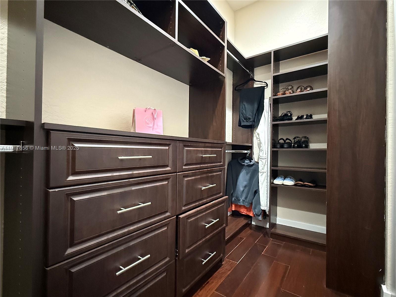 14896 Southwest 38th Street Davie, FL 33331 - Photo 44 of 60 a view of walk in closet with clothes and shoes