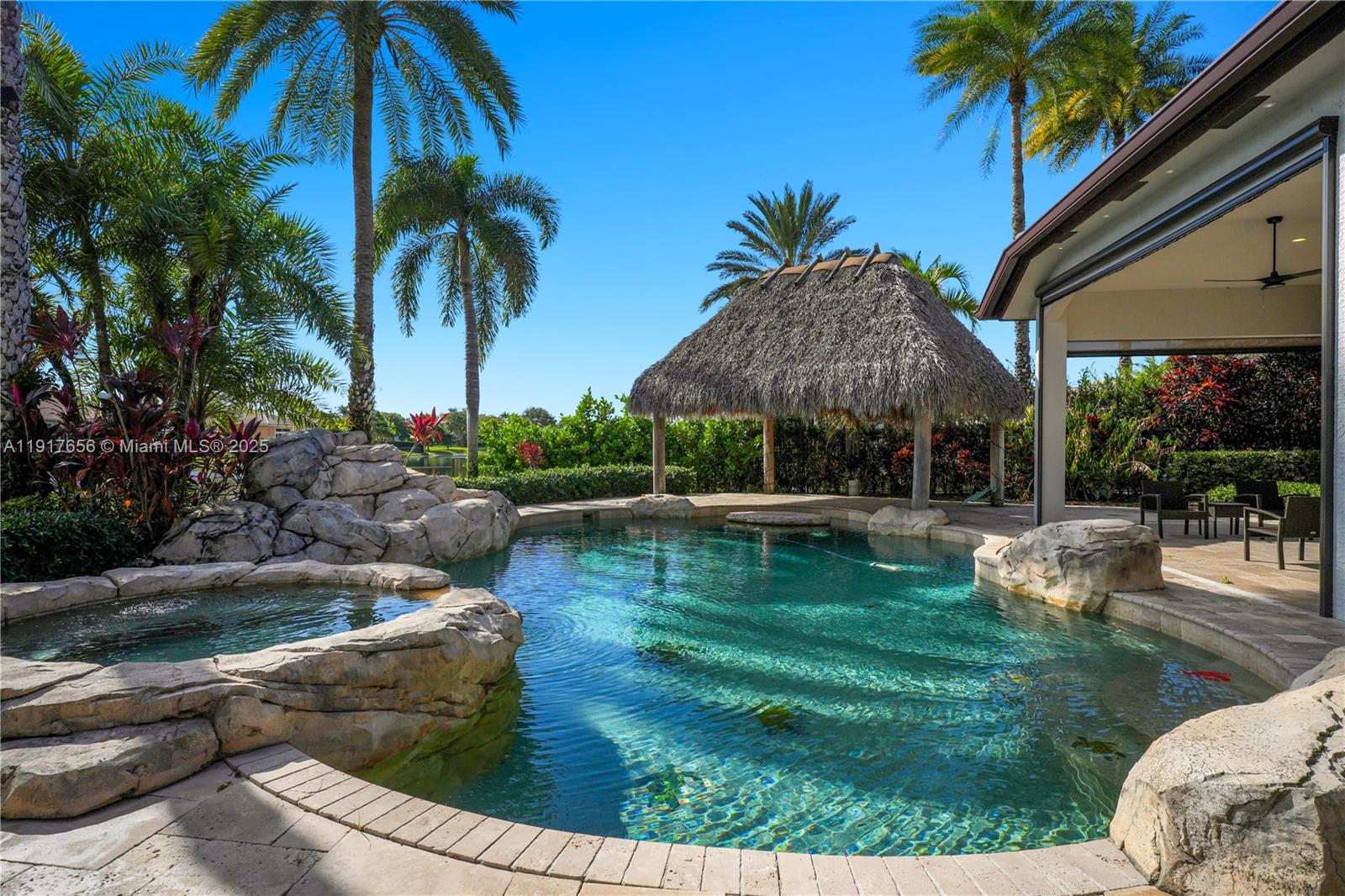 14896 Southwest 38th Street Davie, FL 33331 - Photo 49 of 60 a view of a swimming pool with a patio and a yard