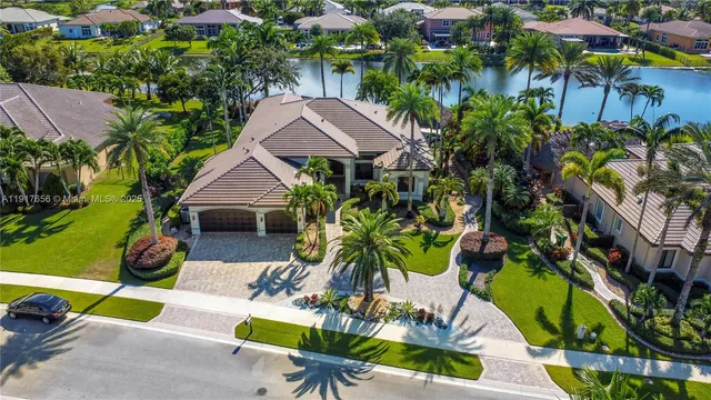 an aerial view of a house with swimming pool garden and patio