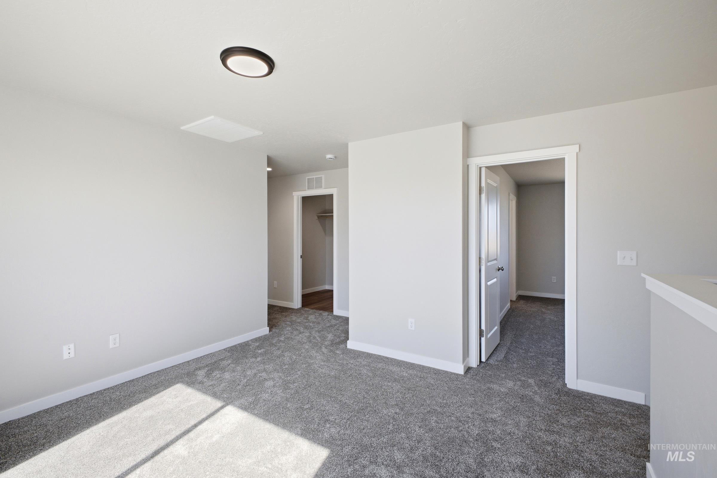 13325 Scrape Street Caldwell, ID 83607 - Photo 14 of 24 Spacious primary suite featuring neutral wall finishes, recessed ceiling lighting, and direct access to multiple closet spaces